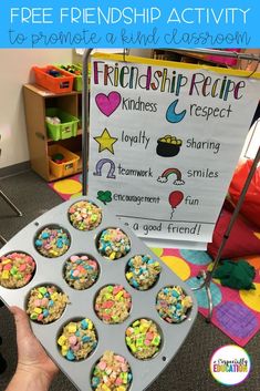 a person holding up a cupcake in front of a sign that says, friendship recipe