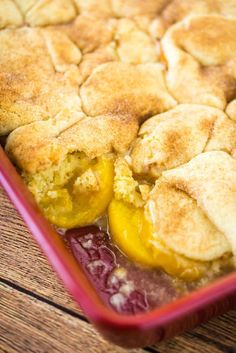 a casserole dish with two yellow peppers in it and some bread crumbs on the side