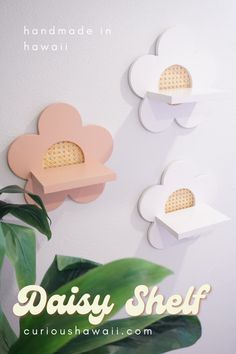 three flower shaped shelves on the wall with text overlay reading daisy shelf, handmade in hawaii