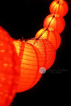 many red lanterns are hanging in the dark