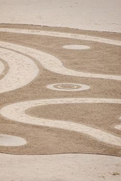 a person riding a motorcycle on a dirt road in the middle of an empty field