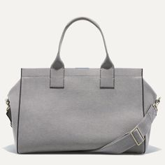 The Overnighter in Stone Grey
Structured design in soft grey, with a double-zipper top closure and durable bag feet.
Padded top handles and an adjustable, detachable shoulder strap in soft grey for maximum versatility.
Main compartment fits a change of clothes, toiletries and accessories.
Side compartment features a magnetic closure and interior zip pocket to keep your laptop, wallet and passport handy.
 
Height: 11.8 in / 30 cmLength: 13.4 in / 34 cmDepth: 7.9 in / 20 cmHandle drop: 7.1 in / 18 cmStrap length: 59.1 in / 150 cmWeight: 3.3 lb / 1.5 kg Essential Pouch, Crafts From Recycled Materials, Padded Top, Statement Bag, Stone Grey, Zipper Top, Grey Stone, Overnight Bag, Blue Accents