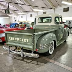 an old pick up truck parked in a garage