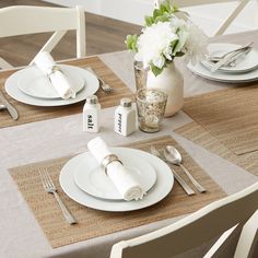 a table set with place settings and silverware