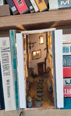 a book shelf filled with books and an open door to another room full of books