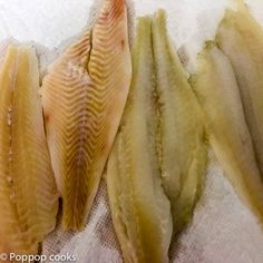 three fish fillets on a white towel