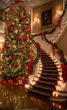 a decorated christmas tree in the middle of a room with stairs and candles on it