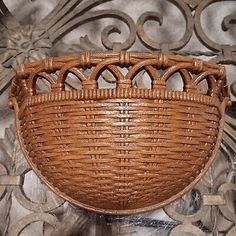 a brown wicker basket hanging on a wall