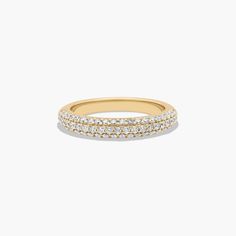 a yellow gold ring with rows of diamonds on the outside, and two rows of white stones