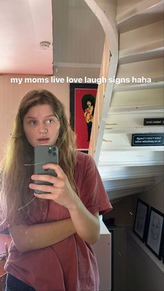 a woman taking a selfie with her cell phone in front of her face and text that reads, my moms live laugh laugh signs hate