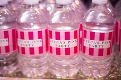 pink and white striped water bottles with labels on them for party guests to drink from