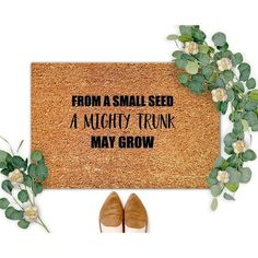 a door mat that says, from a small seed to a mighty trunk may grow