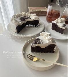 two slices of chocolate cake on plates with forks