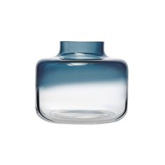 a blue glass vase sitting on top of a white table