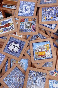 there are many blue and white tile coasters on the table in front of each other