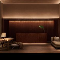 a living room with wooden walls and a plant on the table in front of it