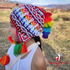 "\"Chullo\"/Unisex Peruvian colorful hat with ear flaps, is the perfect accessory for Winter. They are woven and embroidered by hand by Artisans of the Andes in Peru, with white beads, the beads are sewn one by one. This particular colorful hat has a design of the \"Sun - Inti\", in the time of the Incas, he was the Inca god of the sun and was considered to be all-powerful, but also a benevolent god and capable of great generosity. The bright color combinations are unique in the region. This hat will be perfect for going out of the house, it will keep you warm in winter. The size is one size, easily fits a 13 year old, up to an adult. Ideal garment for a gift, surprise those you love the most with this alpaca hat. At SonqoPeruArt we offer the best quality and we assure you that we will mee Traditional Multicolor Beaded Hat, Handmade Bohemian Costume Hats For Winter, Festival Multicolor Beaded Hats, Colorful Handmade Hats For Festivals, Multicolor Bohemian Costume Hats And Headpieces For Festivals, Handmade Colorful Festival Hats, Bohemian Multicolor Handwoven Hat, Colorful Bohemian Crochet Hat, Bohemian Multicolor Crochet Hat For Festival