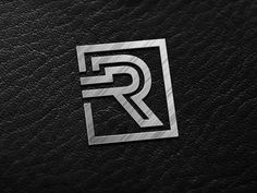 the letter r is made up of silver metal and has a square shape with a diagonal edge