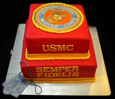 a cake made to look like two red books with the usmc seal on top