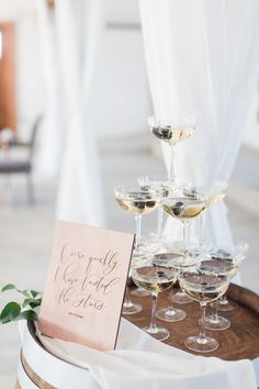 wine glasses are sitting on top of a barrel