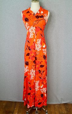 "Description: - 1960s, 1970s Bright Orange Hawaiian Maxi by Kehaulani Item Details: - Adorable summer maxi in a hibiscus Hawaiian print - Empire waist - Ruffle detail at the neckline - Slim, form fitting bodice in structure / silhouette - Maxi, full skirt Condition: - This dress is in great vintage condition - There are no rips, stains, or tears Measurements: *Marked Size XS Bust: 34 in Waist: 26 in Shoulder to Hem: 56 in Purveyor's Note: We have searched far and wide, wrestled bears, braved the Vintage Printed Dress For Vacation, Retro Tropical Print Dress For Vacation, Retro Printed Vacation Dresses, Retro Tropical Print Vacation Dress, Sleeveless Retro Maxi Dress For Vacation, Vintage Printed Beach Dress, Vintage Printed Maxi Dress For Beach, Vintage Printed Maxi Dress For Vacation, Tropical Orange Floral Print Maxi Dress