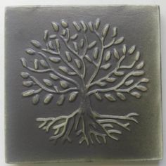 a square tile with a tree on the bottom and leaves on the top, in grey