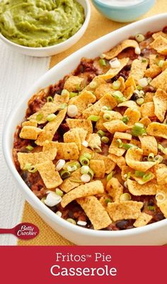 a white casserole dish filled with chips and salsa