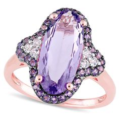 This stunning gemstone ring is sure to catch the eye. Crafted from high-quality sterling silver with rose rhodium plate, its dazzling design features a striking 16.0 x 7.0mm oval-shaped amethyst in bright purple, flanked on either side by trios of shimmering white topaz. The central gemstone is surrounded by a delicate frame of smaller amethyst gems, creating a truly dynamic and luxurious look. With its bold and unique design, this ring is the perfect accessory for any occasion. Please note that as a custom-made item, this ring cannot be resized after purchase.The perfect complement to any elegant style, this ring will be hand-made exclusively to your order by our skilled jewelers. Please allow 7-9 business days for processing.Product ID: GLD-TA-133138Precious Metal Type: Rose Sterling Sil Amethyst Cocktail Ring, Elongated Oval, Ring Purple, Glamorous Style, Bright Purple, Fabulous Jewelry, Black Rhodium, Topaz Gemstone, 2 Carat