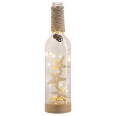 a bottle filled with gold stars on top of a wooden base and string wrapped around it