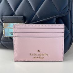 Kate Spade Madison Saffiano Leather Small Slim Card Holder Color: Conch Pink Nwt New With The Tag Authentic Product Details 3.94" W X 2.8" H X 0.4" D Saffiano Leather Ksny Metal Pinmount Logo Two Way Spade Jacquard Lining Exterior: 6 Credit Card Slots, Open Middle Compartment Dust Bag Not Included Imported Style No. Kc582 Ksny - Kate Spade New York Editor's Notes Here's A Place To Stash Concert Tickets, Photographs, Secret Love Notes...Oh, And Credit Cards Of Course. Kate Spade Wallet Pink, Planner Wallet, Luxury Wallets, Kate Spade Heart, Kate Spade Disney, Kate Spade Card Holder, Pink Wristlet, Handbag Essentials, Cute Wallets