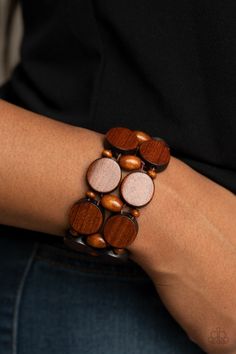 a close up of a person wearing a wooden bracelet