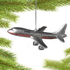 an airplane ornament hanging from a christmas tree