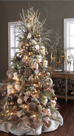 a white christmas tree decorated with ornaments and lights