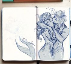 an open notebook with a drawing of two people kissing