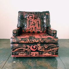 an old leather chair with designs painted on it