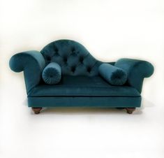 a blue couch sitting on top of a white floor