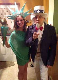 two people dressed up as the statue of liberty