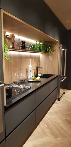 a modern kitchen with wooden cabinets and stainless steel appliances, is pictured in this image