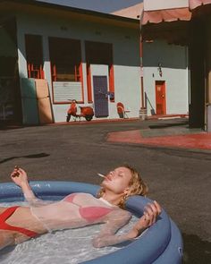 a woman laying in an inflatable swimming pool