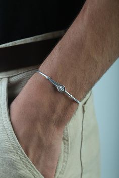 Discover the timeless elegance of our 925 sterling silver men's cuff bracelet, a masterful blend of rugged durability and sophisticated design. Handcrafted with meticulous attention to detail, this bracelet embodies a sleek, minimalist aesthetic that complements both casual and formal attire. Its robust construction ensures lasting strength while maintaining a refined edge, making it a versatile accessory for the modern man. Enhance your connection with a partner through our elegant matching bra Mens Cuff Bracelets, Mens Cuff, Bracelet Mens, Couples Gift, Sterling Silver Mens, Matching Bracelets, Silver Cuff, Silver Man, Modern Man