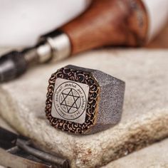 Invoke the wisdom of antiquity with this handcrafted 31-gram silver ring, centered with the Seal of Solomon on an octagonal plaque. A symbol steeped in legend and lore, this substantial ring is both an impressive statement piece and a nod to mystical traditions. Designed for the discerning individual, it's a weighty testament to craftsmanship and history. * Discover our handmade Agate stone minimal ring in silver natural gemstone classic men accessory sterling silver. Find more to here: * https: University Symbol, Solomon Seal, King Solomon Seals, Seal Of Solomon, Solomons Seal, King Solomon, Minimal Ring, The Wisdom, Spiritual Jewelry