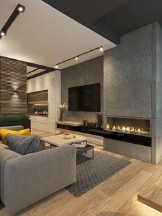 a modern living room with wood floors and gray couches in front of a fireplace