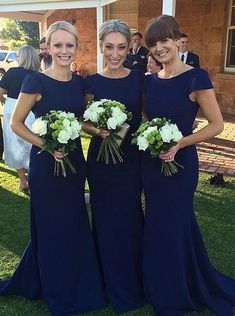 the bridesmaids are posing for pictures in their navy blue dresses and bouquets