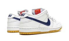 The Nike SB Dunk Low Orange Label “White/Navy” is an easy-wearing colorway of the low-top skate shoe by Nike SB that was released exclusively at skate shops.  High in versatility and comfort whether cruising on a skateboard or walking in the streets, the “White/Navy” features a modest design that includes white leather on the perforated toe, mid-panel, collar, and heel.  The overlays are also constructed in white leather, as well.  A navy blue leather Swoosh logo appears on either side of the sh Dunk Low Orange, Nike Sb Dunk Low Pro, Nike Sb Dunk Low, Sb Dunk Low, Nike Sb Dunks Low, Nike Sb Dunk, Nike Brand, Skate Shoe, Nike Sb Dunks