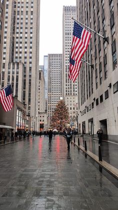 people are walking down the street with american flags