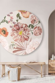 a white room with flowers painted on the wall and a wooden bench in front of it