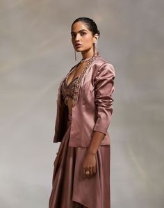 Editor's Note Style a traditional look with a solid lapel jacket with hand embroidery detailing Note: Blouse and skirt worn by model is for styling purposes only. Color: Mauve Fabric: Heavy Satin Fit type: Tailored Components: Jacket Occasion: Party Care: Dry Clean Only About the Designer The crux and essence of the label, Divya Aggarwal, is to challenge and revamp the face of ordinary traditional wear while being customer oriented. Driven by the values of individuality and creativity, this cont Divya Aggarwal, Mauve Fabric, Blouse Yoke, Personal Shopping Service, Notes Style, Embroidery Detailing, Lapel Jacket, Traditional Wear, Modern Vibe