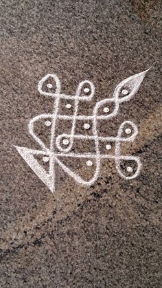 an artistic drawing on the ground with white lines and dots in it's center