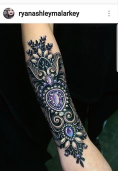 a woman's arm with an intricate design on it