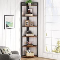 a living room with a chair and a book shelf in the corner on the wall